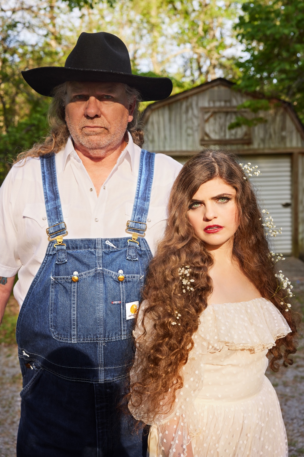 Nettie and the Delta Boy outdoors beside a weathered shed